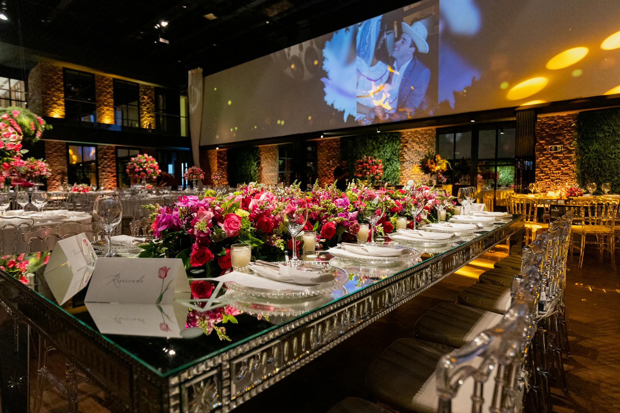 Luxurious wedding reception setting with vibrant floral arrangements and elegant decor.